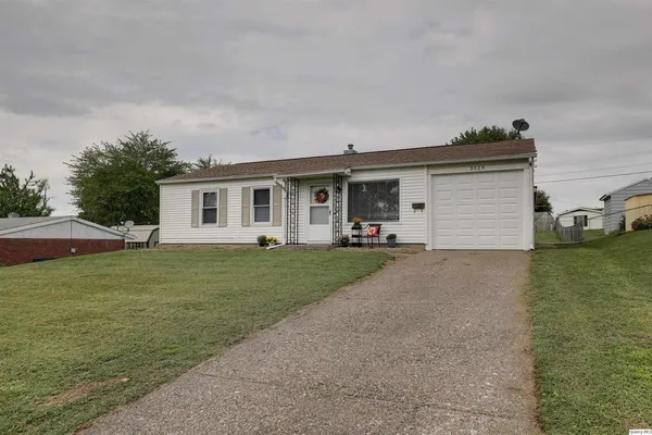 a front view of house with outdoor seating and yard