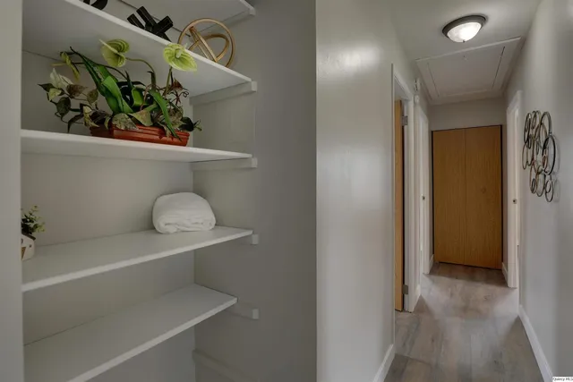 a hallway with painting and wooden floor