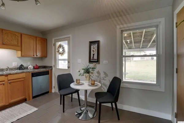 a kitchen with a table chairs and a window