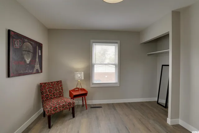 a view of a room with lounge chair and wooden floor
