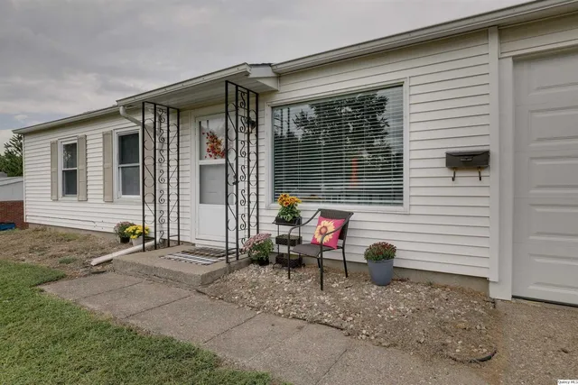 a backyard of a house with table and chairs