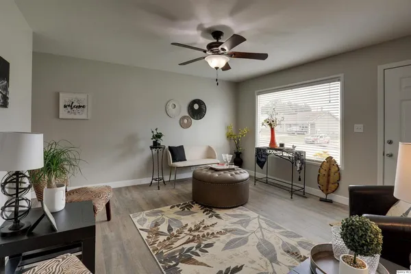 a living room with furniture and a large window