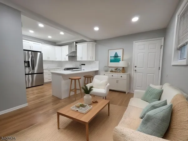 a living room with furniture and kitchen view