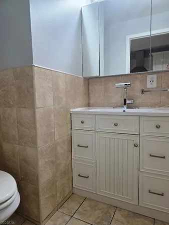 a bathroom with a sink a toilet and vanity