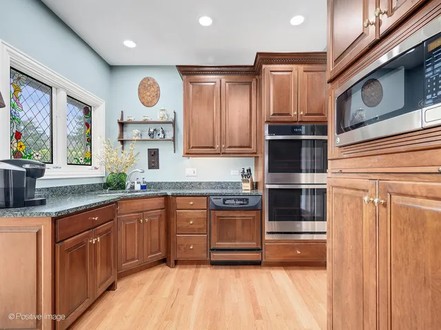 a kitchen with stainless steel appliances granite countertop a refrigerator and a sink