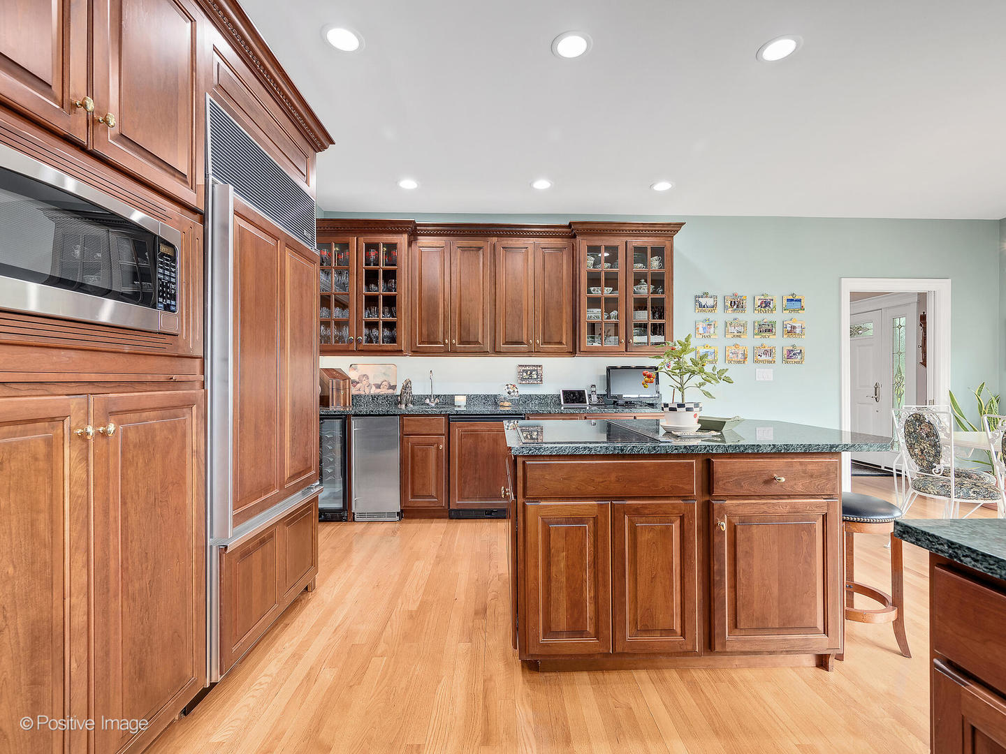 802 Kenmare Drive Burr Ridge, IL 60527 - Photo 19 of 43 a kitchen with stainless steel appliances granite countertop a refrigerator and wooden cabinets