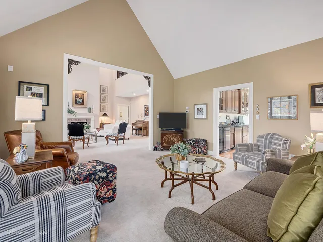 a living room with furniture fireplace and a large mirror