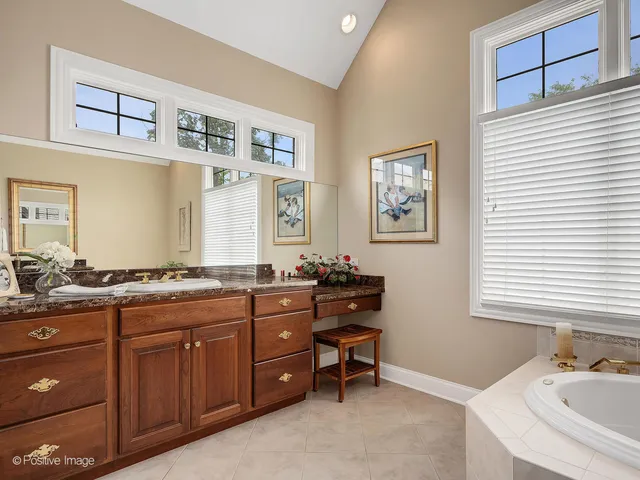 a spacious bathroom with a granite countertop sink mirror and a