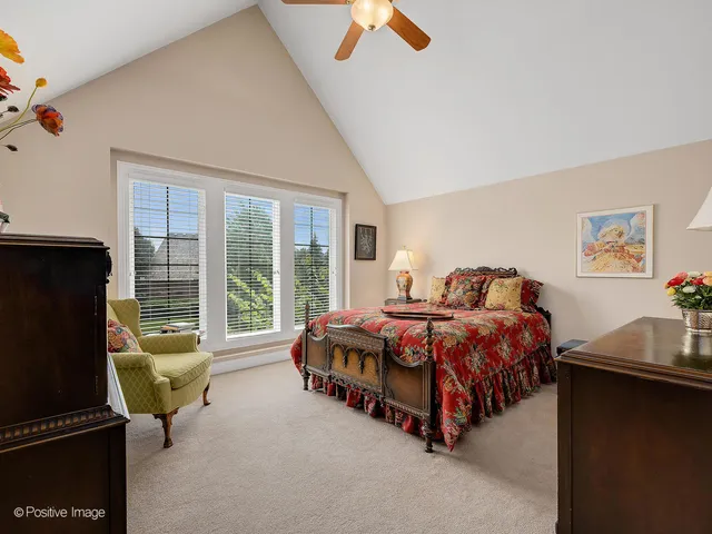 a spacious bedroom with a bed and glass door