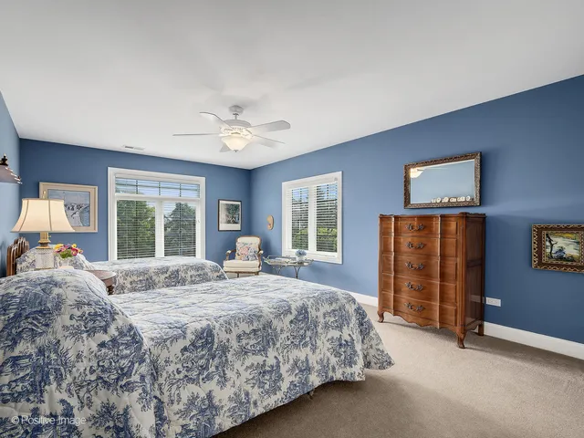a spacious bedroom with a bed and a chandelier