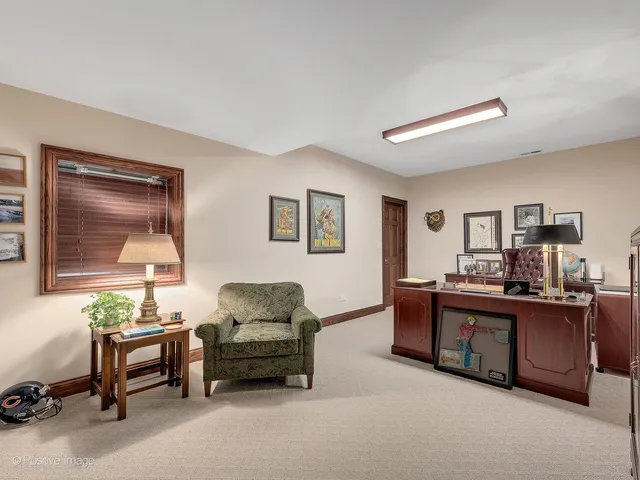 a living room with furniture and paintings on the wall