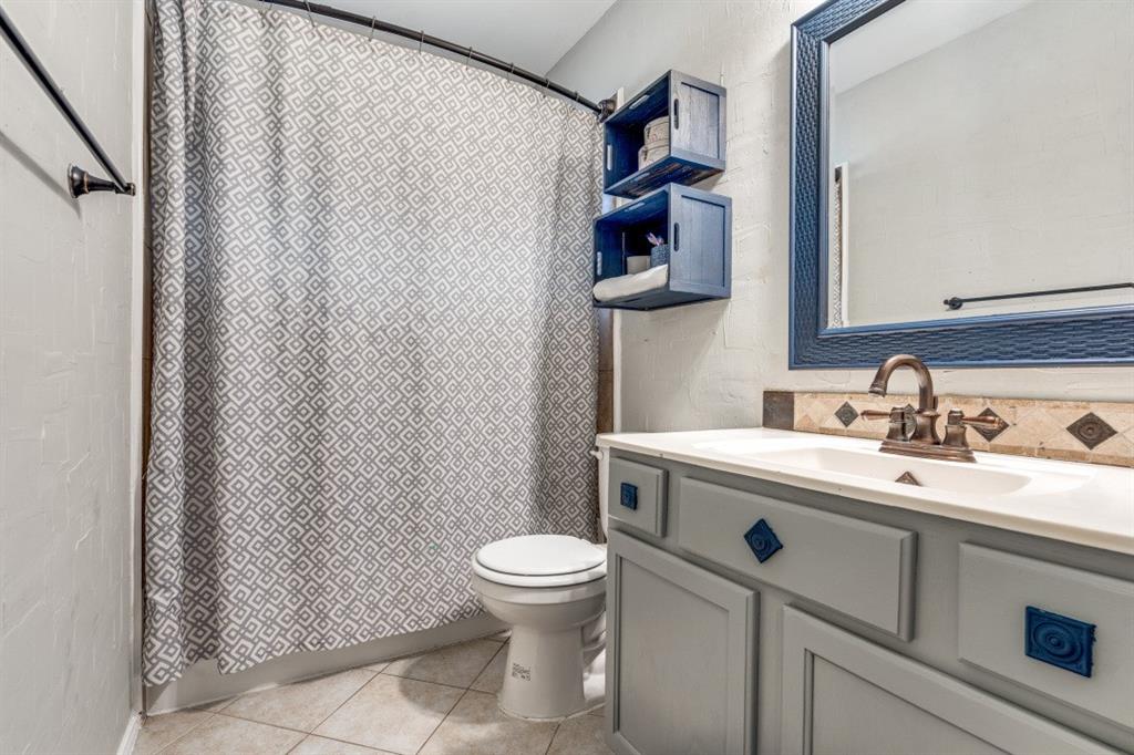 2031 Knights Court Allen, TX 75013 - Photo 11 of 12 a bathroom with a sink and a toilet