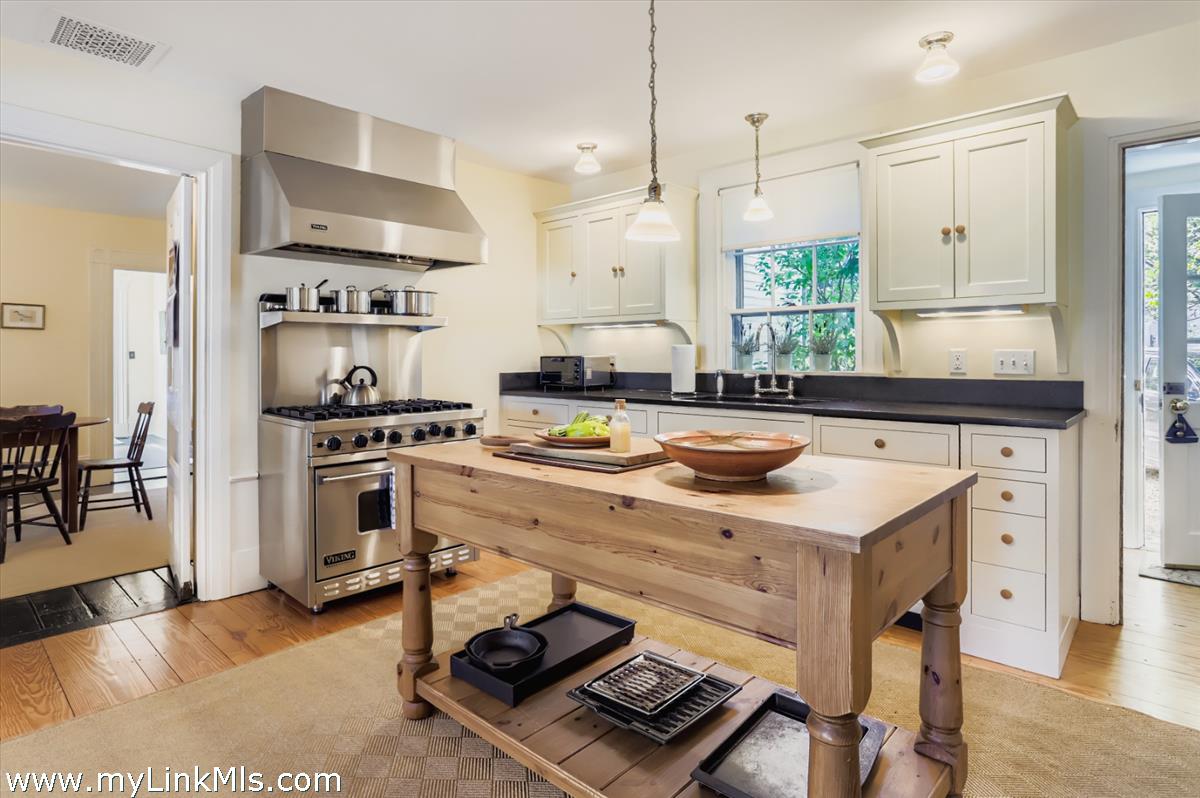 27 Spring Street Vineyard Haven, MA 02568 - Photo 15 of 58 a kitchen with kitchen island a stove a sink and a refrigerator