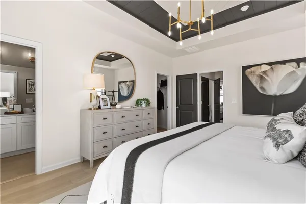 a bedroom with a large bed and ceiling fan