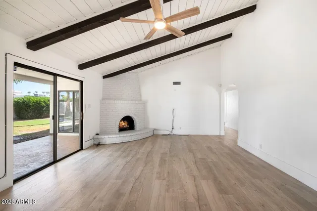 a view of a room with wooden floor and a window