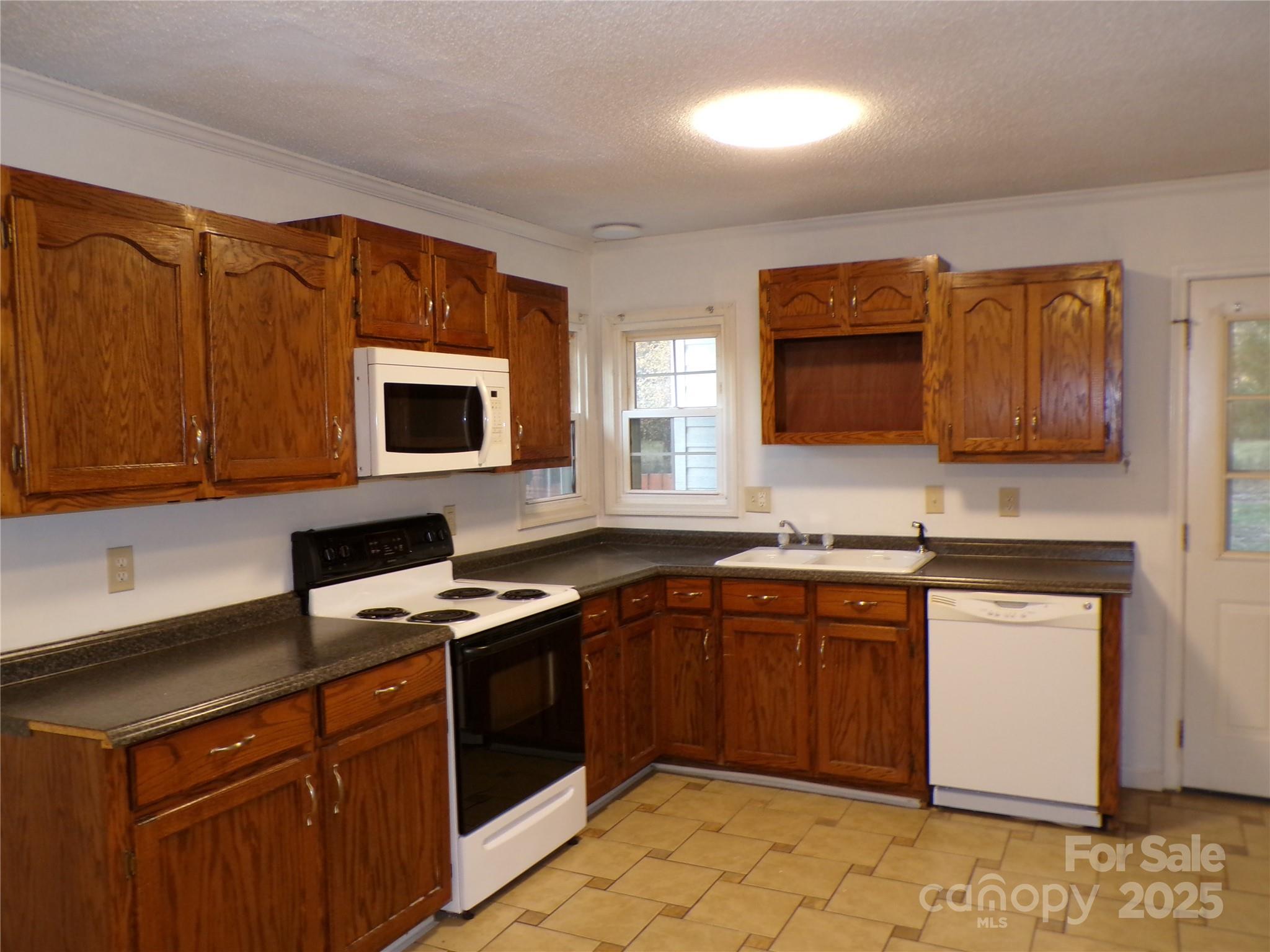 5391 Sapp Road Kannapolis, NC 28083 - Photo 7 of 15 a kitchen with stainless steel appliances granite countertop a sink stove and microwave