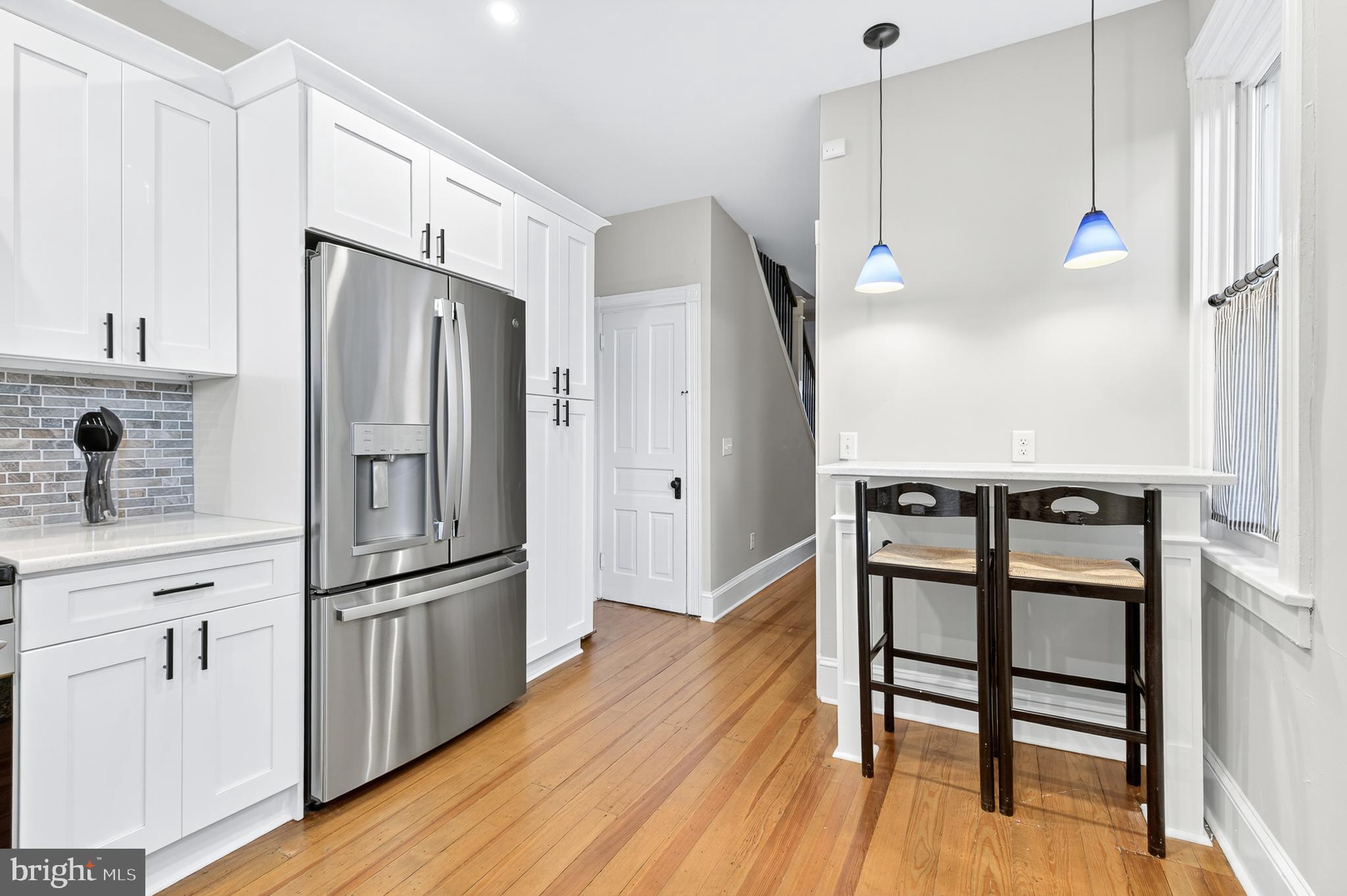 624 St Joseph Street Lancaster, PA 17603 - Photo 18 of 44 a kitchen with stainless steel appliances a refrigerator a sink dishwasher a stove and white cabinets with wooden floor