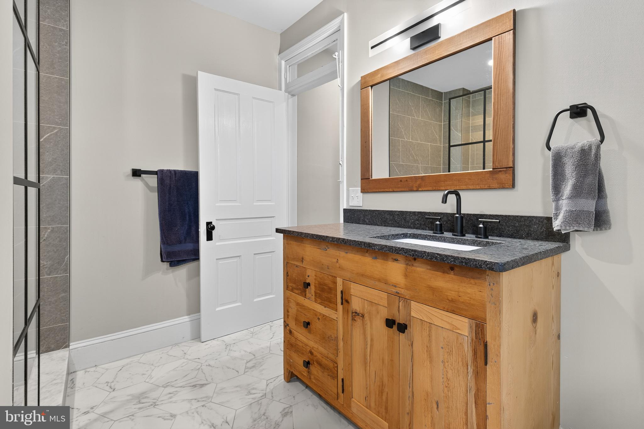 624 St Joseph Street Lancaster, PA 17603 - Photo 29 of 44 a bathroom with a granite countertop sink and a mirror