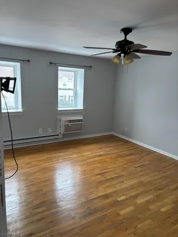 a view of a room with wooden floor and window