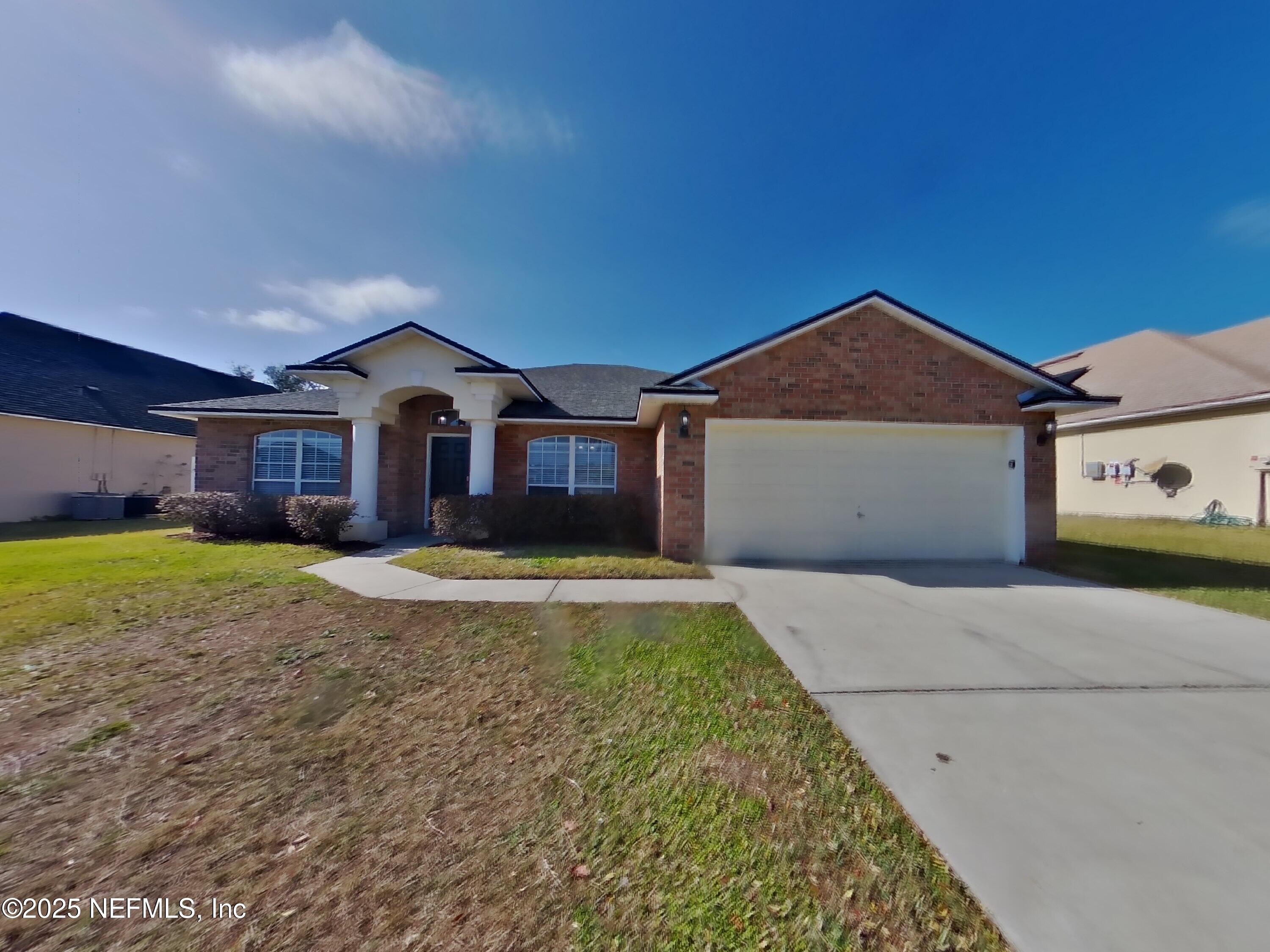 984 Fox Chapel Lane Jacksonville, FL 32221 - Photo 1 of 15 a front view of a house with a yard and garage