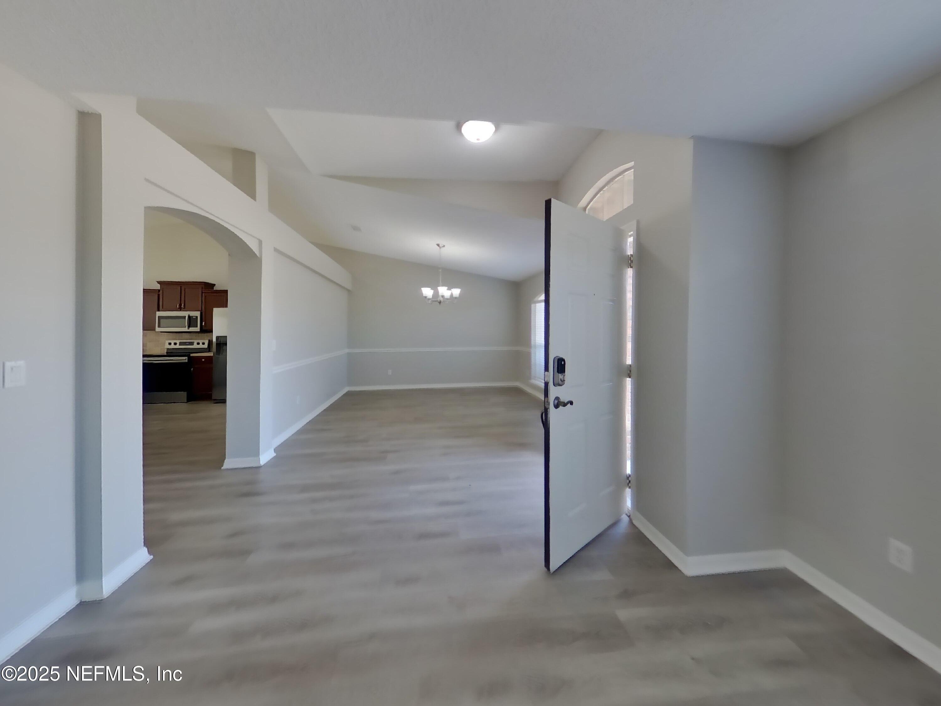 984 Fox Chapel Lane Jacksonville, FL 32221 - Photo 13 of 15 an empty room with wooden floor and windows