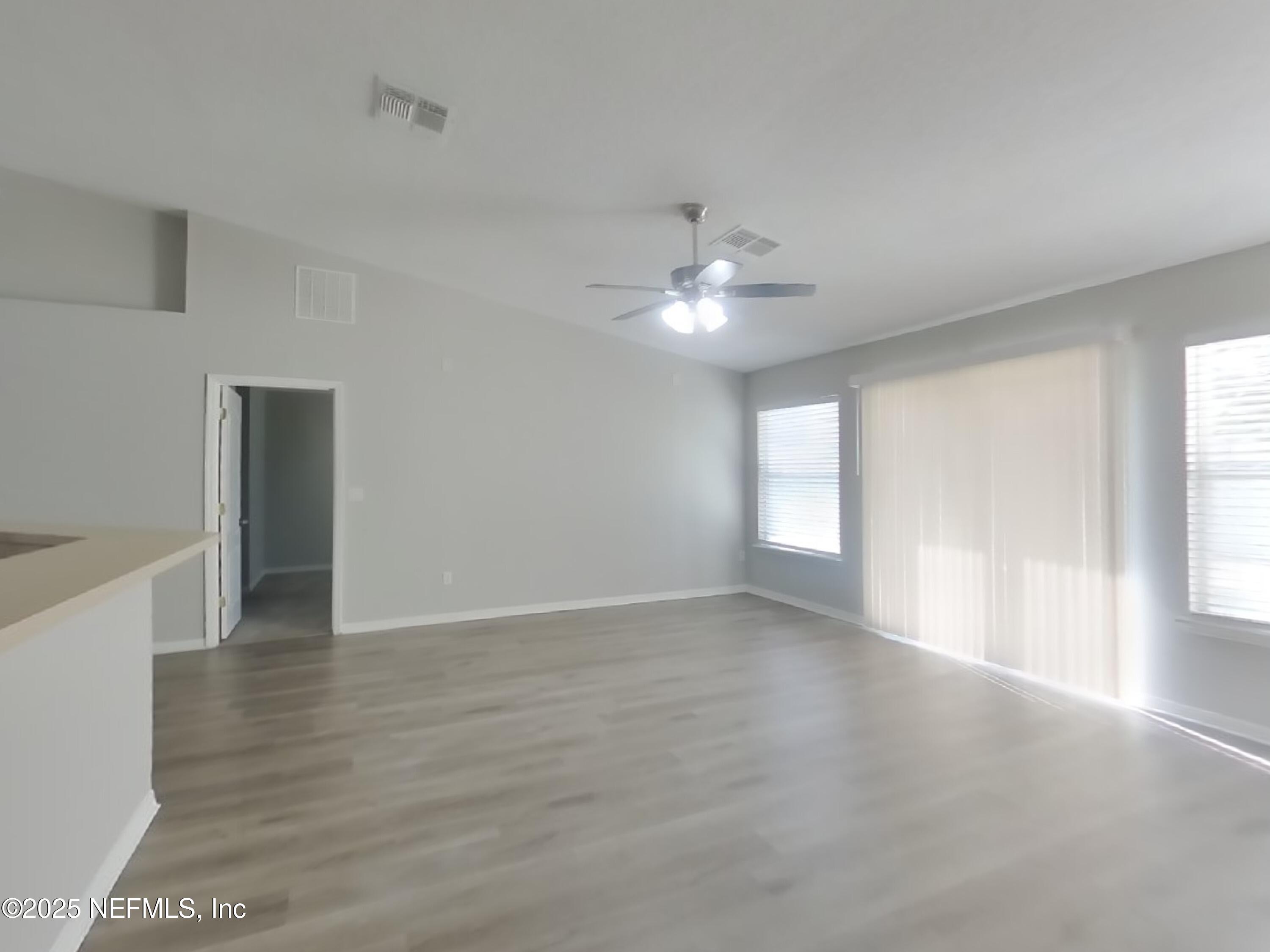 984 Fox Chapel Lane Jacksonville, FL 32221 - Photo 2 of 15 a view of an empty room with window and wooden floor