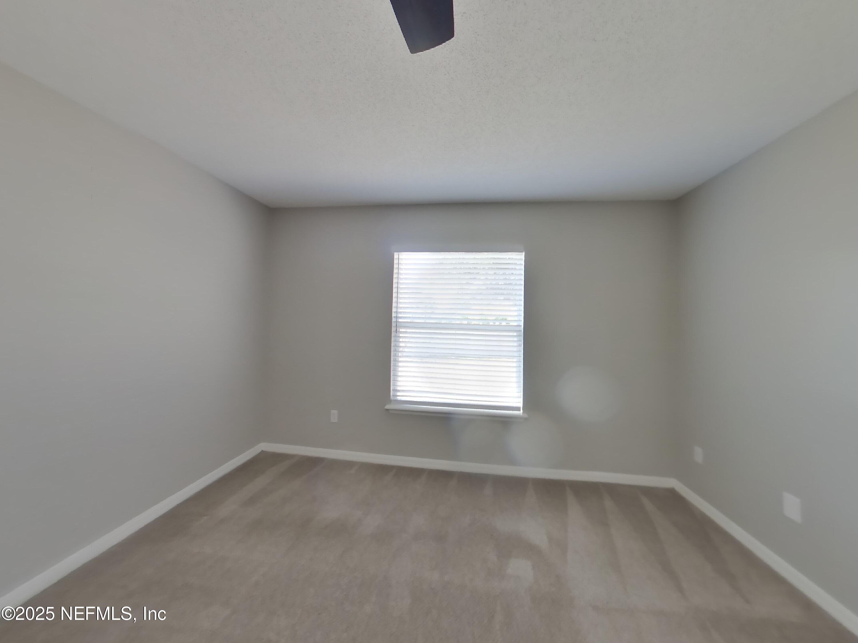 984 Fox Chapel Lane Jacksonville, FL 32221 - Photo 6 of 15 an empty room with a window