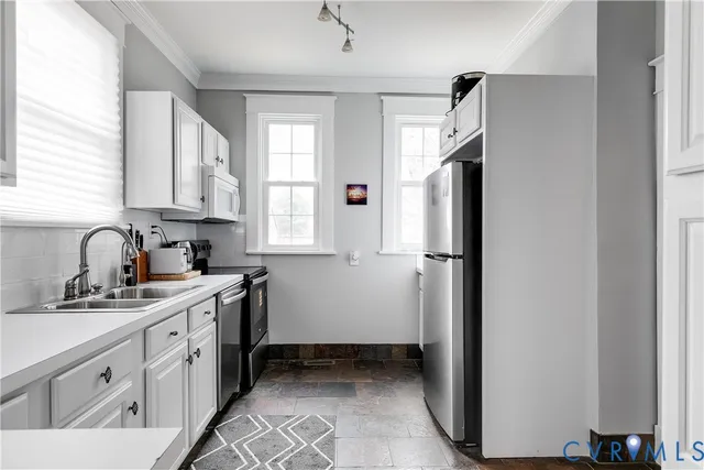 a kitchen with stainless steel appliances a refrigerator sink and cabinets