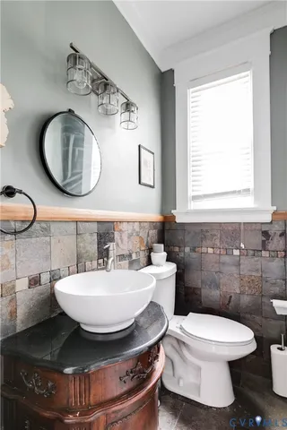 a bathroom with a toilet a sink and a mirror