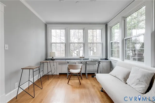 a living room with furniture and large windows