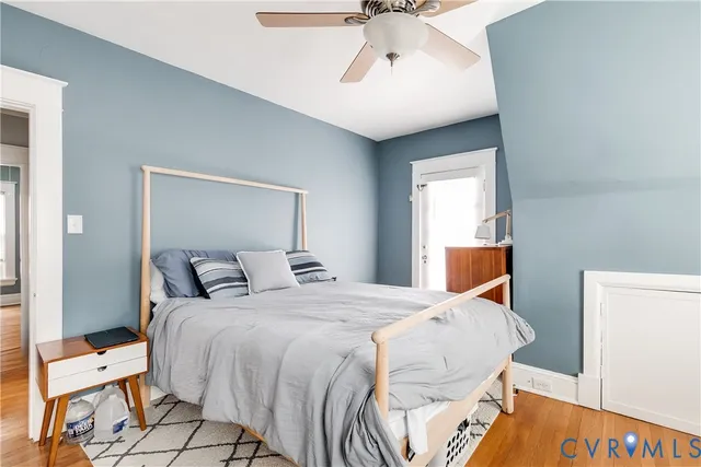 a bedroom with a bed and wooden floor