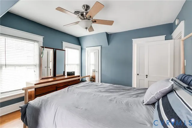 a bedroom with a large bed and a large window