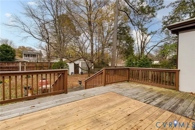 a balcony with wooden floor and fence