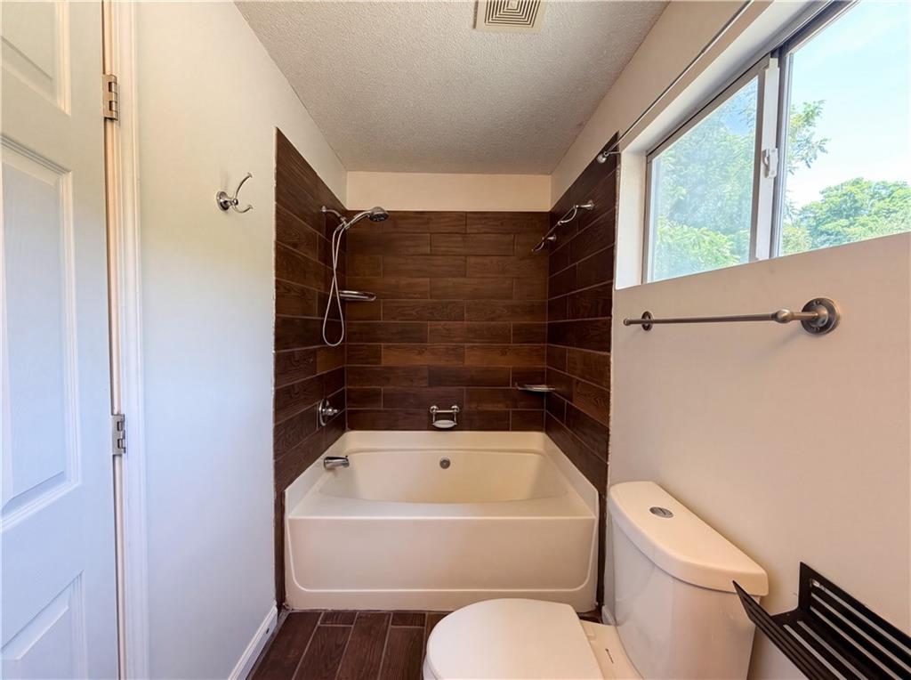 3753 Soapstone Road Decatur, GA 30034 - Photo 18 of 26 a bathroom with a toilet and a bathtub