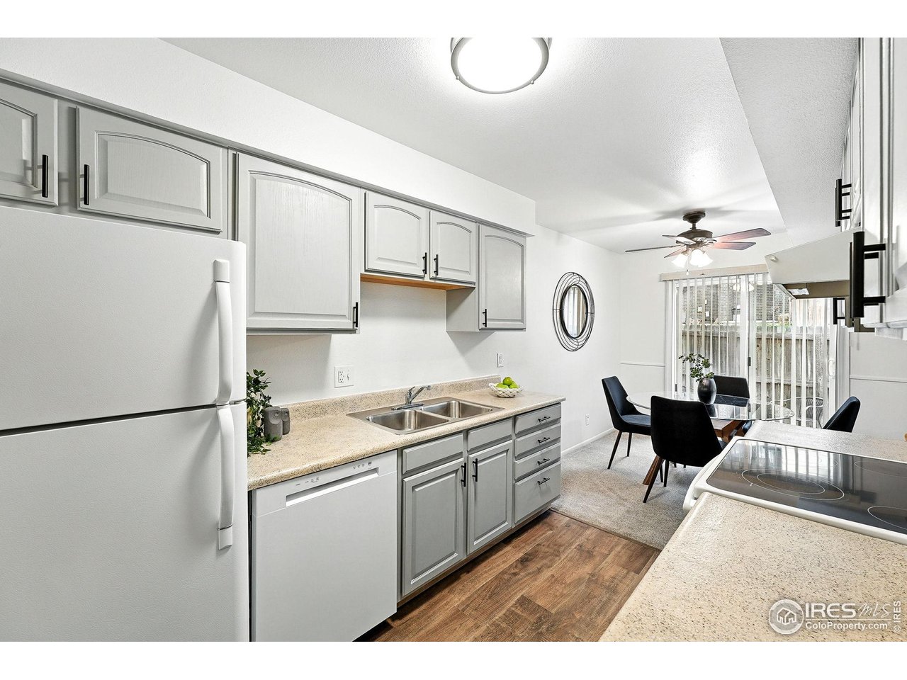 9857 Lane Street Thornton, CO 80260 - Photo 13 of 38 a kitchen with kitchen island a stove a refrigerator and a dining table