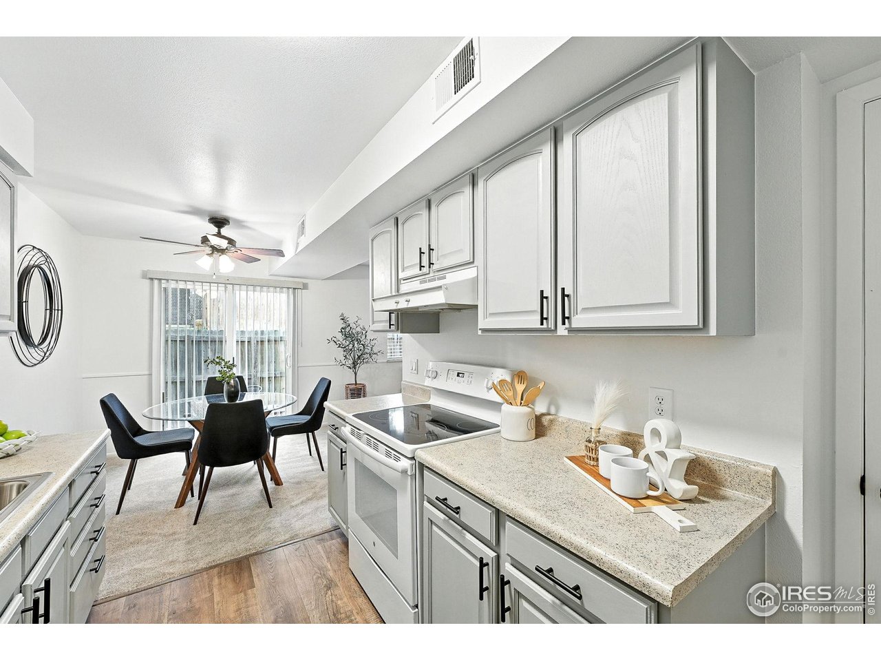 9857 Lane Street Thornton, CO 80260 - Photo 14 of 38 a kitchen with stainless steel appliances granite countertop a sink stove and cabinets