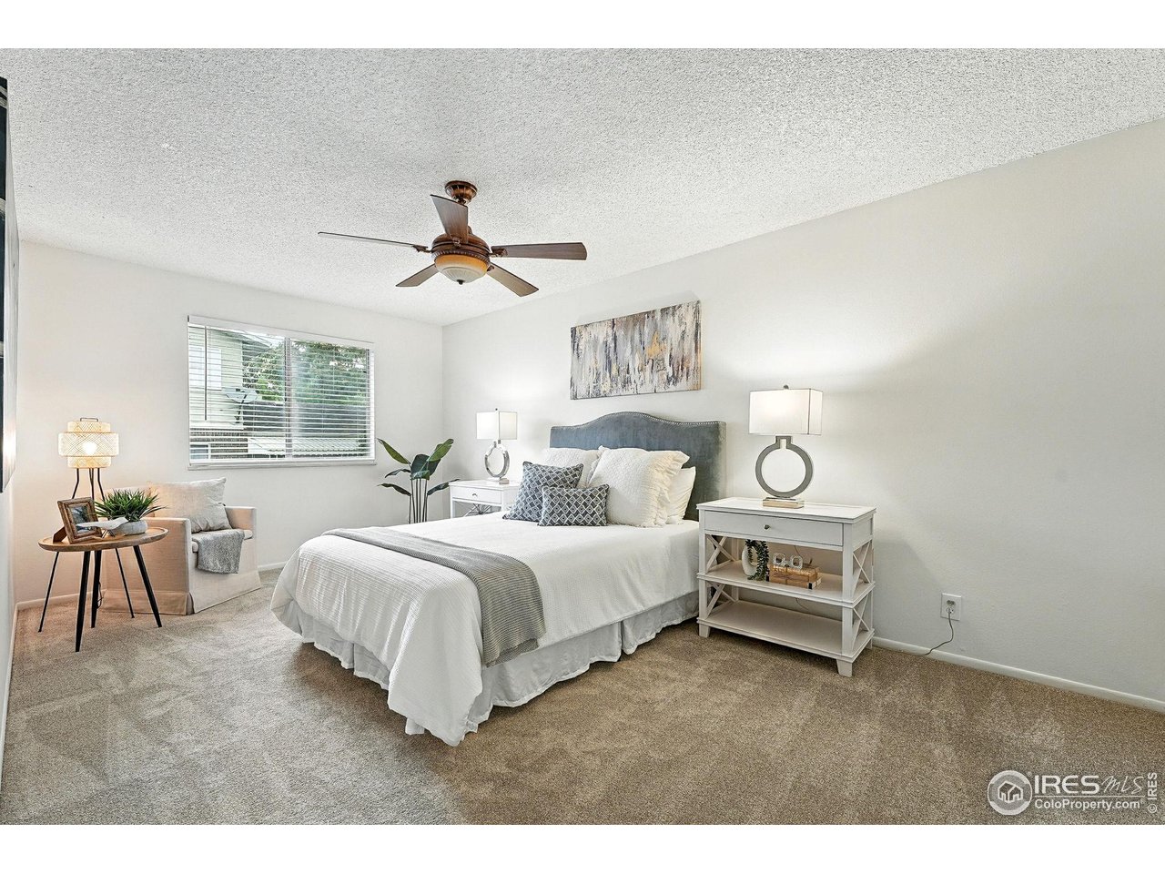 9857 Lane Street Thornton, CO 80260 - Photo 18 of 38 a spacious bedroom with a bed and a table