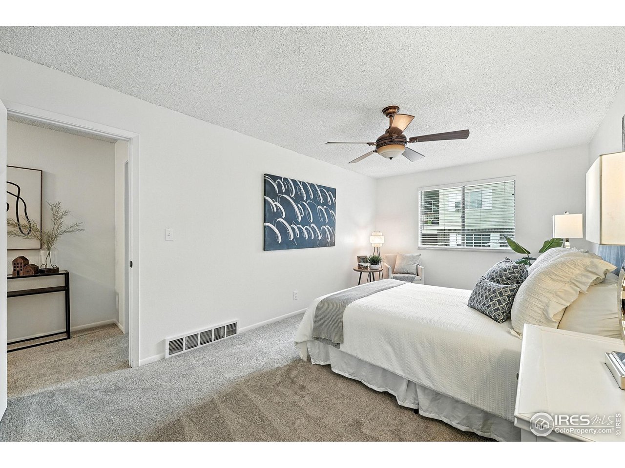 9857 Lane Street Thornton, CO 80260 - Photo 19 of 38 a bedroom with a bed and a chandelier