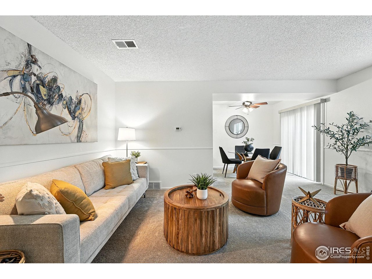 9857 Lane Street Thornton, CO 80260 - Photo 2 of 38 a living room with furniture and a chandelier