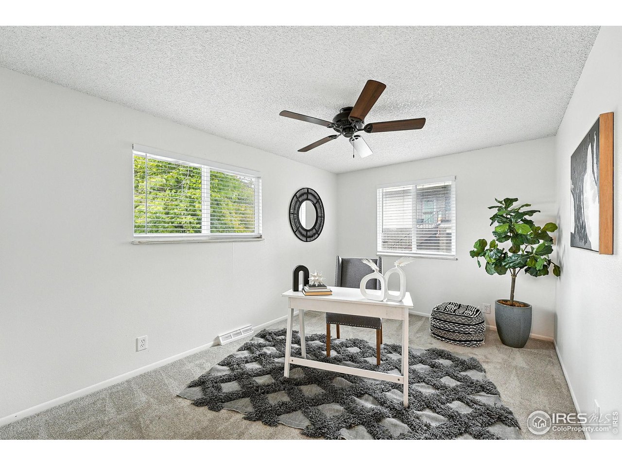 9857 Lane Street Thornton, CO 80260 - Photo 22 of 38 a living room with furniture a window and a potted plant