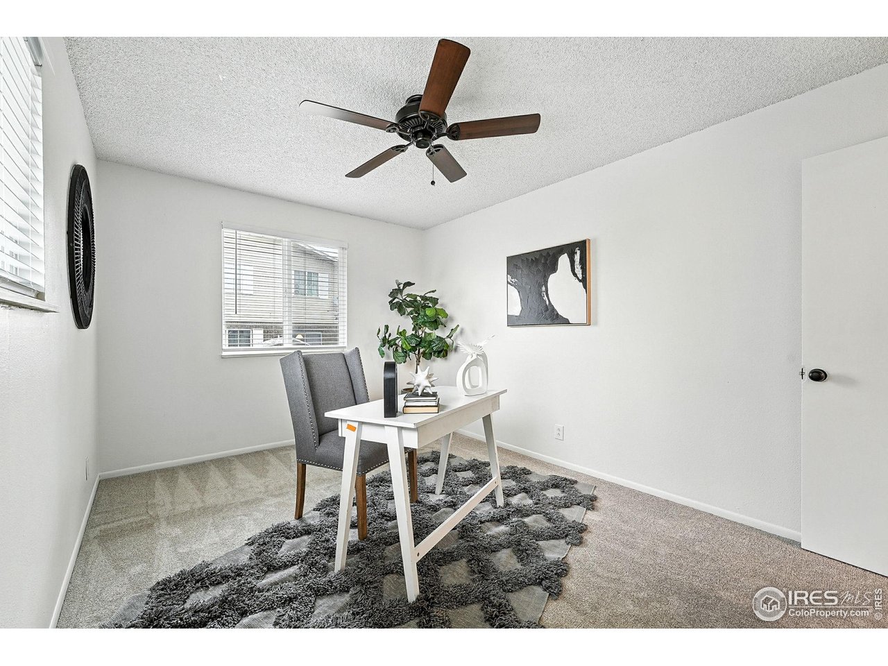 9857 Lane Street Thornton, CO 80260 - Photo 23 of 38 a view of a workspace with furniture and window