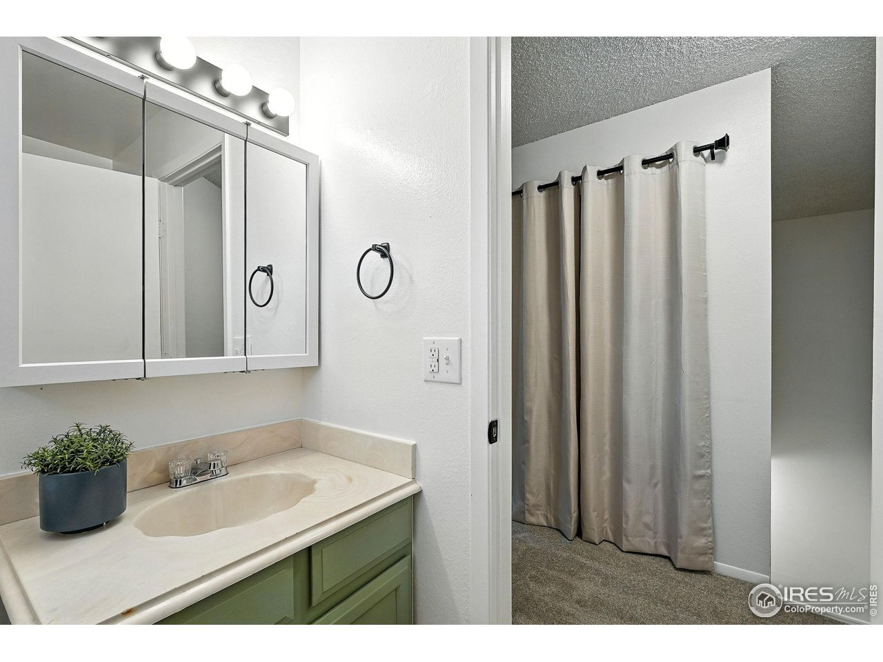 9857 Lane Street Thornton, CO 80260 - Photo 26 of 38 a bathroom with a sink and a mirror