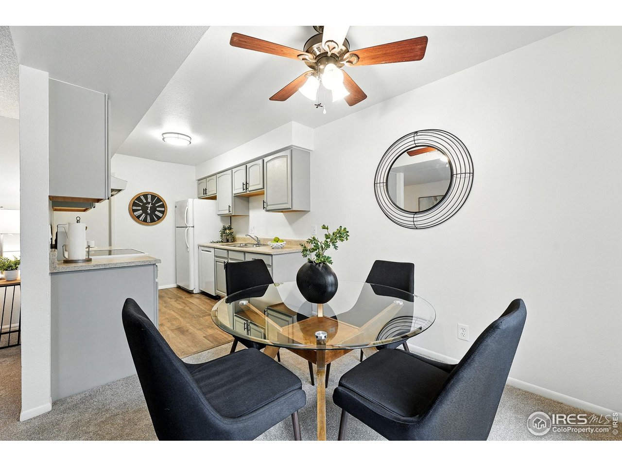 9857 Lane Street Thornton, CO 80260 - Photo 3 of 38 a dining room with furniture and a chandelier fan