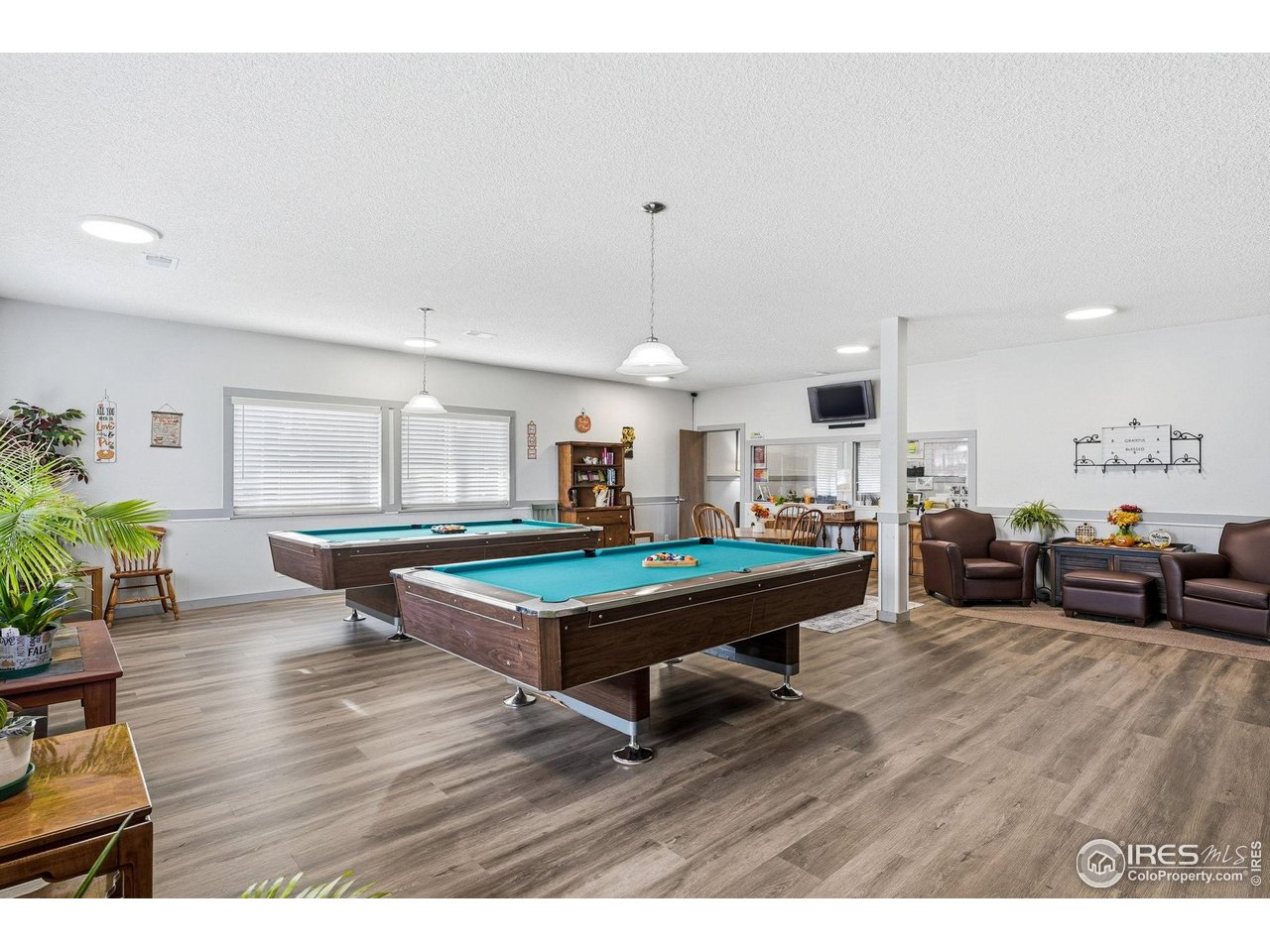 9857 Lane Street Thornton, CO 80260 - Photo 34 of 38 a living room with furniture and wooden floor