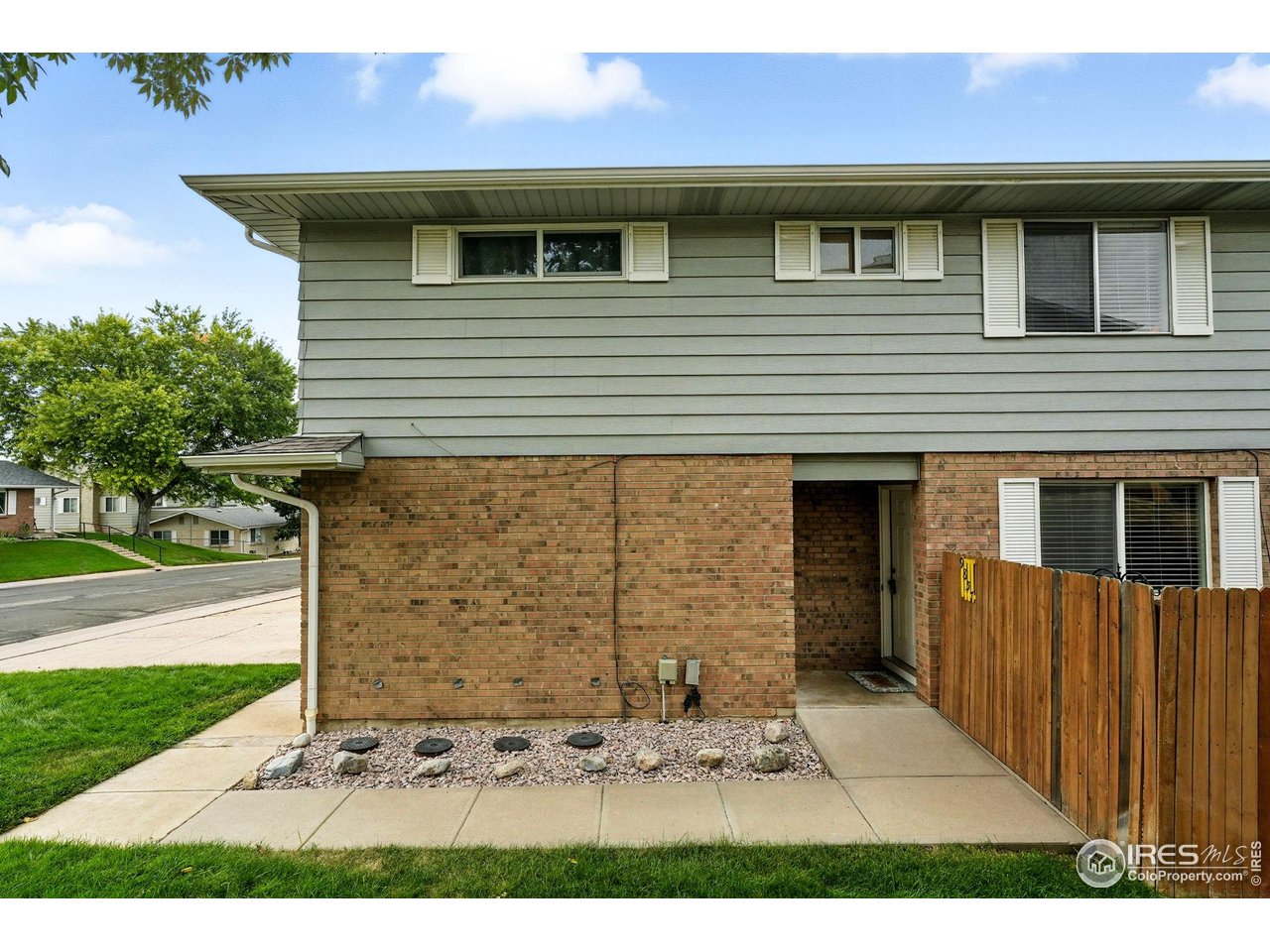 9857 Lane Street Thornton, CO 80260 - Photo 6 of 38 a front view of a house with a yard