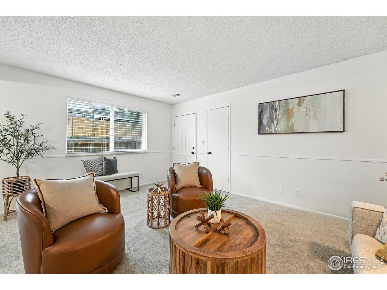 9857 Lane Street Thornton, CO 80260 - Photo 9 of 38 a living room with furniture a window and a flat screen tv