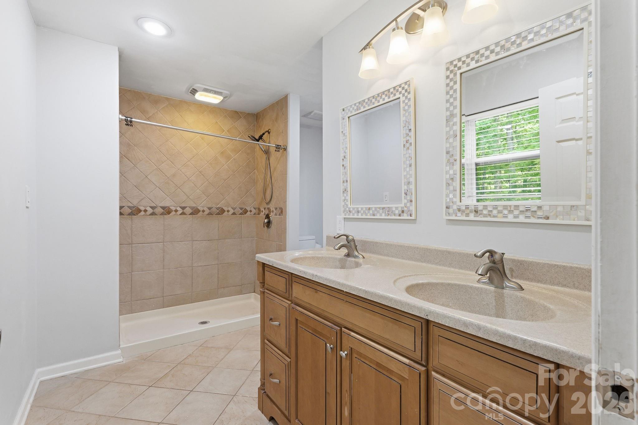5347 Haney Road York, SC 29745 - Photo 27 of 39 a bathroom with a sink double vanity and a shower