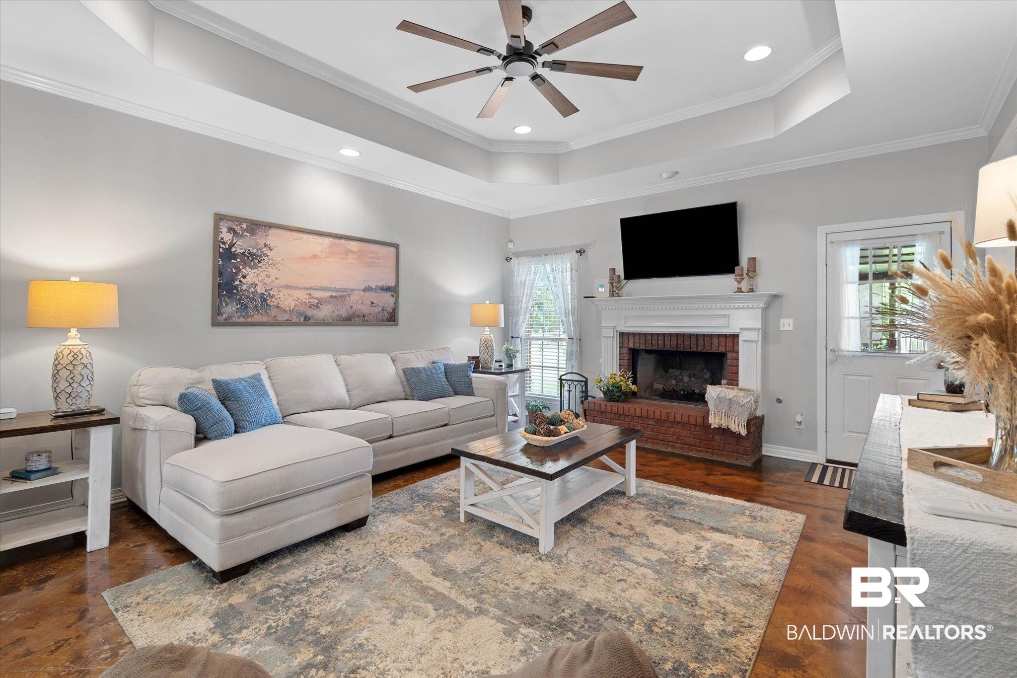3170 Scott Dairy Loop Road West Mobile, AL 36695 - Photo 4 of 24 Spacious living area featuring a brick fireplace with a white mantel, recessed lighting, and a multi-level tray ceiling
