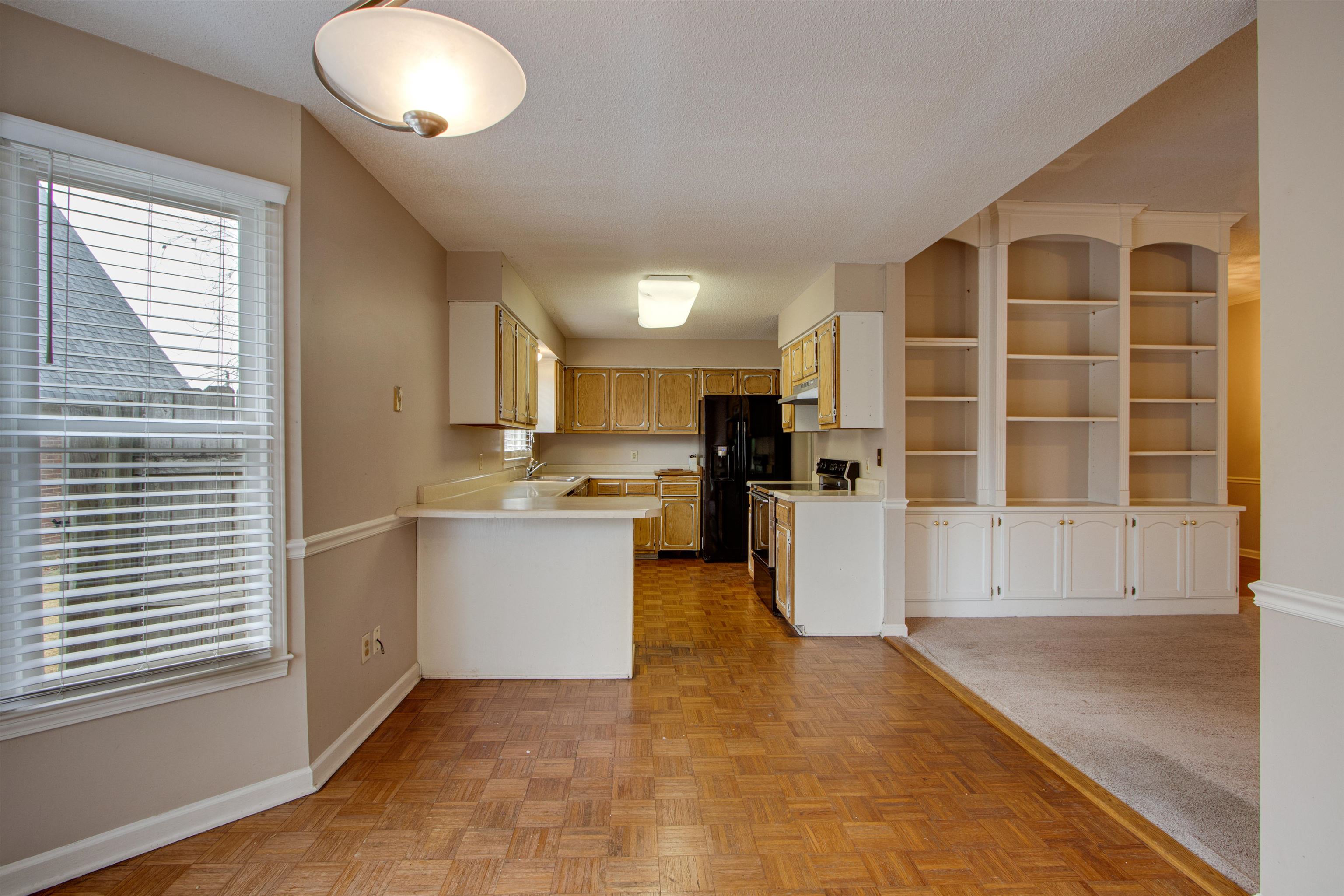 690 Ridge Fall Drive Memphis, TN 38018 - Photo 11 of 28 a kitchen with a refrigerator and a stove