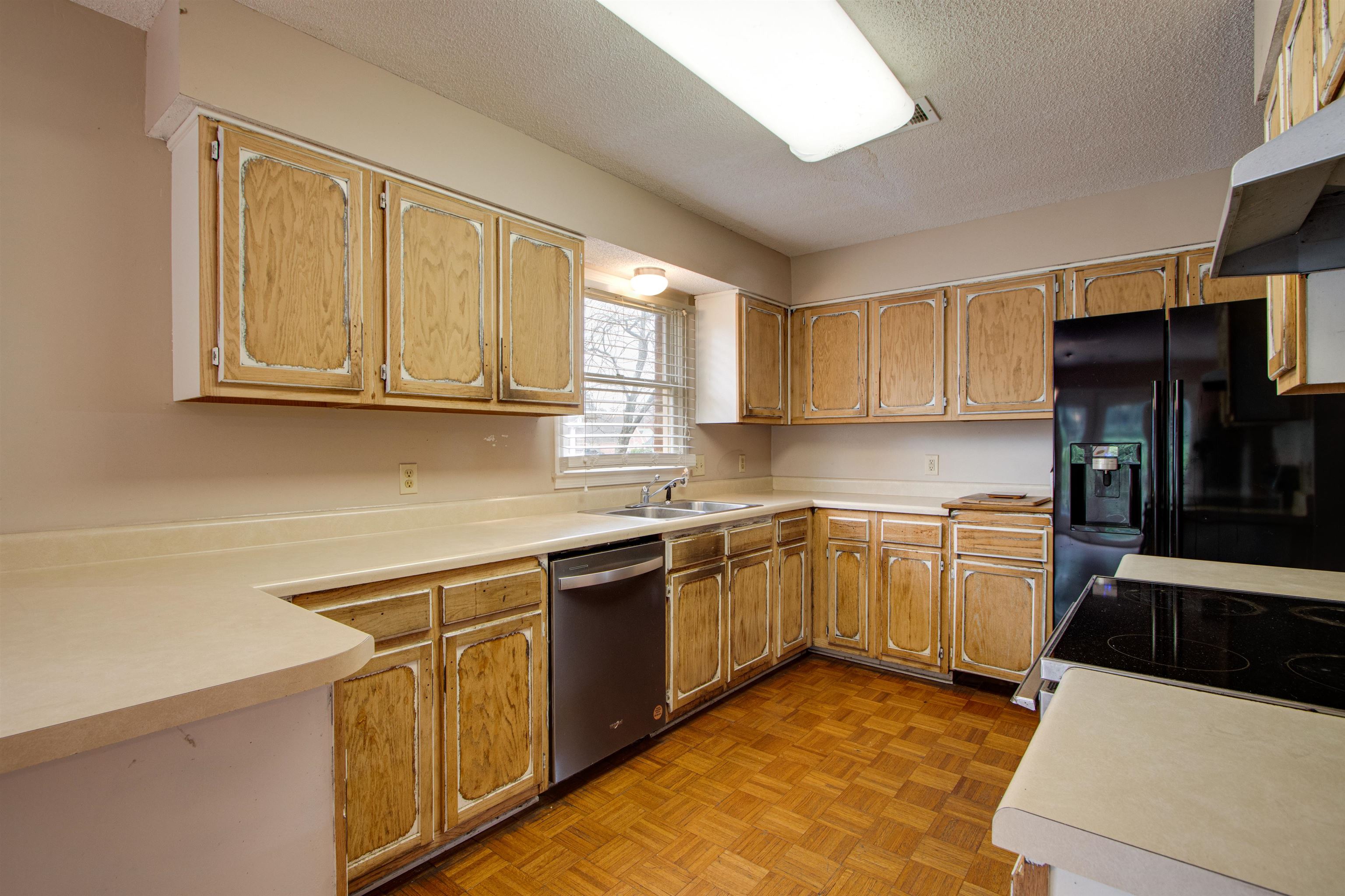 690 Ridge Fall Drive Memphis, TN 38018 - Photo 12 of 28 a kitchen with stainless steel appliances granite countertop a sink stove and refrigerator